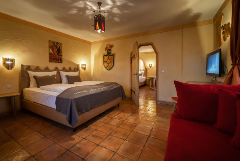 A hotel room with a double bed and a view of the bathroom
